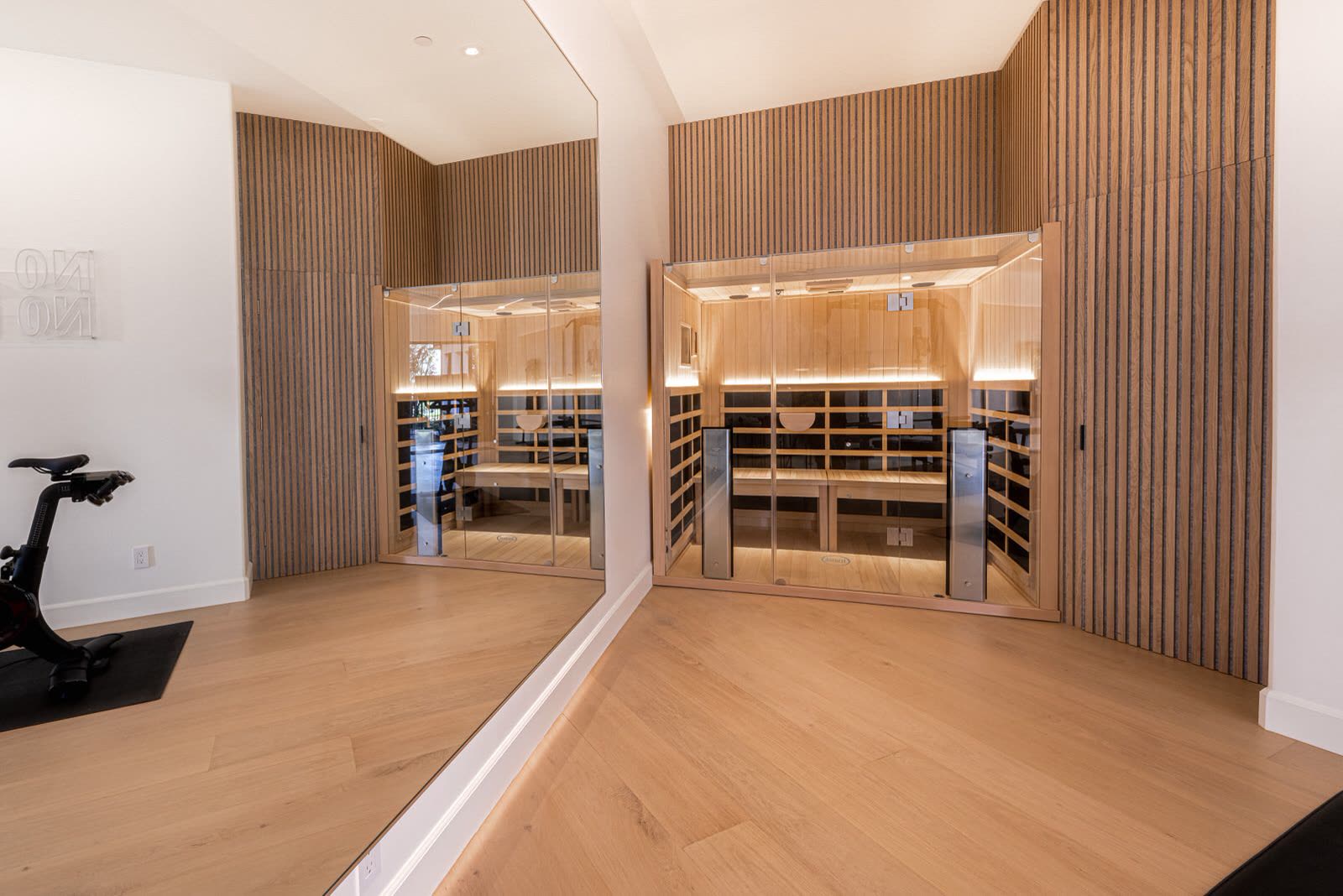 Glass-fronted wine room set into slatted oak panelling